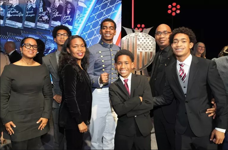Kouri Crump and his family pose for a photo with his trophy.