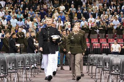 Commissioning cadets march into Cameron Hall during the annual ROTC joint commissioning ceremony in full military uniform.