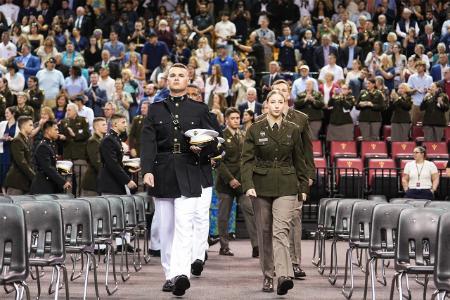 Commissioning cadets march into Cameron Hall during the annual ROTC joint commissioning ceremony in full military uniform.