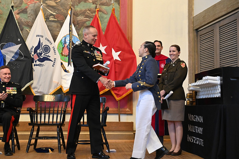Lt. Gen. Furness shakes the hand of a VMI graduating cadet in Memorial Hall.
