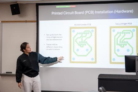 Nicole Samella ’26 explains the use of circuit boards in the project benefitting a disabled veteran.