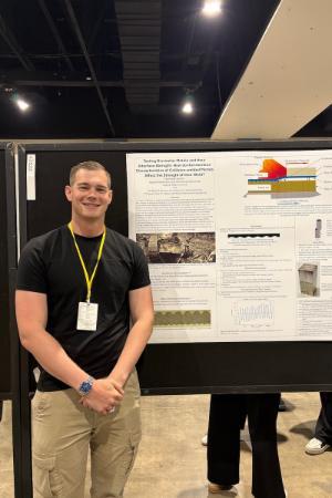 Nicholas Eynon ’26 presents his poster at NCUR in Richmond.
