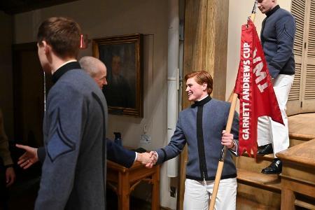 Julia Ward '26 shakes hands with the commandant during rank announcements.