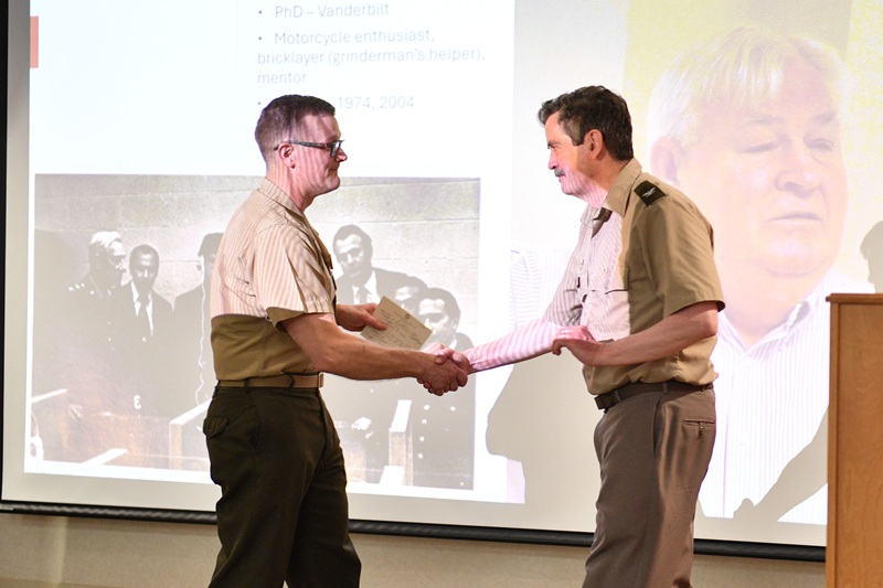 Col. Travis Homiak ’95 congratulates Col. Donald Sunnen on his retirement.