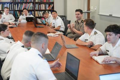 Cadets and professor discuss class materials.
