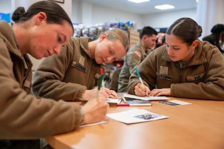 New cadets personalize holiday greeting cards for senior community residents.