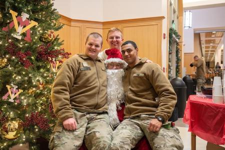 Santa makes a mental note to add a few names to the naughty list as cadets test his muscular fortitude in the PX Dec. 12.
