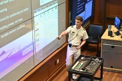 Connor Bott ’26 explains the different types of boat anchors and how they are used during his honors presentation in Scott Shipp Hall.