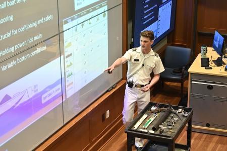 Connor Bott ’26 explains the different types of boat anchors and how they are used during his honors presentation in Scott Shipp Hall.