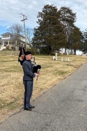 Ben Bowen ’26 plays “Amazing Grace” on bagpipe during National Wreaths Across America Day, Dec. 13 at Evergreen Cemetery.