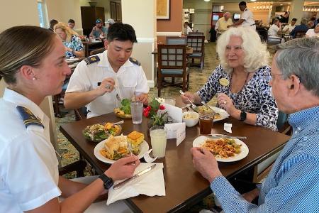 Cameron Jones ’27 and Daniel Moon ’27 enjoy chatting over lunch with Kendal residents, Marise Craig and Paul Cormier