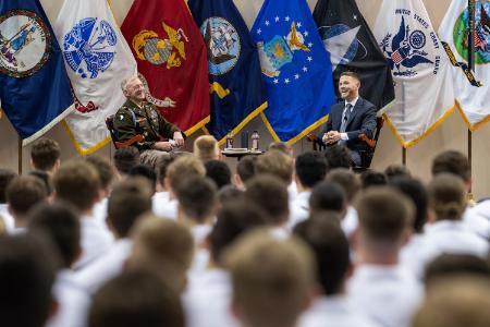 Col. David Gray shares a laugh with Kyle Carpenter during the moderated interview March 9 in Cameron Hall.