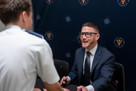 A cadet chats with Kyle Carpenter at his book signing in Cameron Hall.