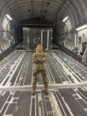 Cadet Johnson stands inside a C-17.