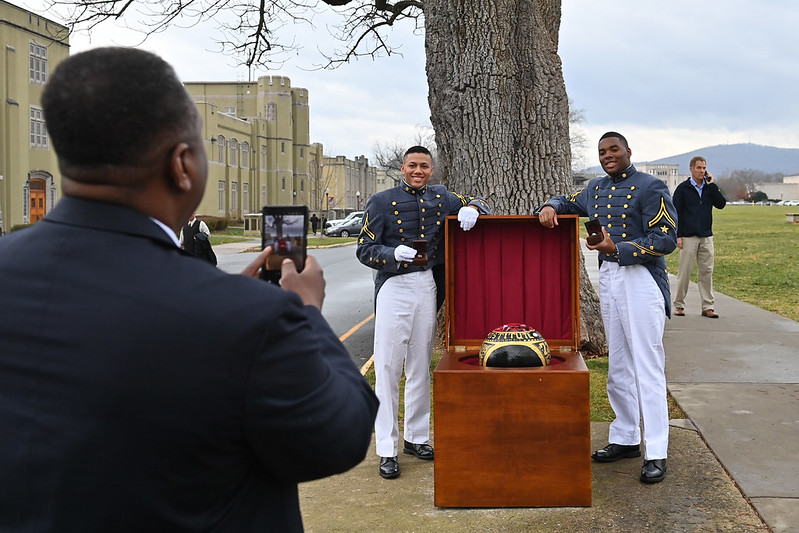 Cadets pose with their rings and the cannonball.