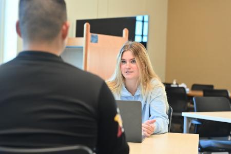 Aurora Abramov ’27 interviews a cadet on protein supplement use for her SURI project.