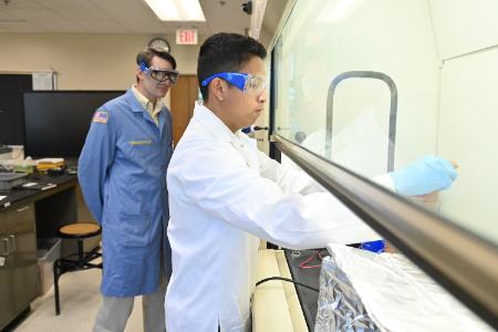Xavier Zarza ’28 demonstrates the electroplating process while Maj. Christopher Shingledecker observes.