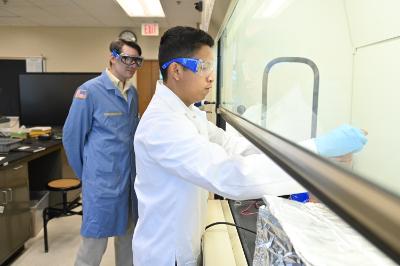 Xavier Zarza ’28 demonstrates the electroplating process while Maj. Christopher Shingledecker observes.