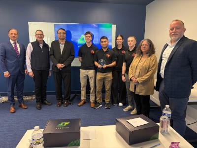 Intelligence and national security professionals surround Col. Imran Ghani, Michael Kelley ’27, John Stotler ’27, Caroline Marini ’26, and River Smith ’27 after their victory at the 2026 Seerist Intellithon.