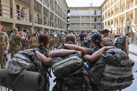 Cadets stand in Barracks with their arms around each other prior to the memorial stair climb.