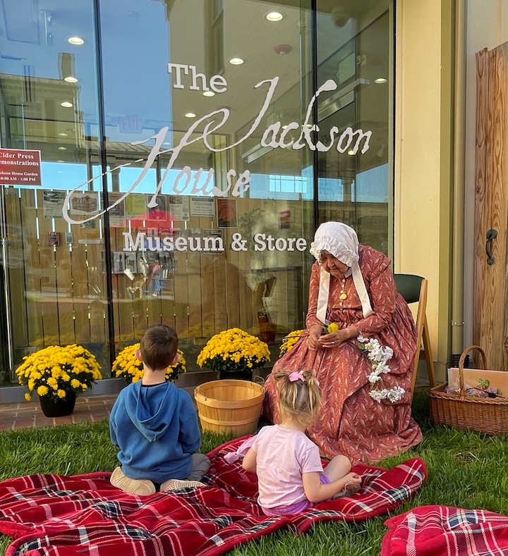 Museum interpreter Tamara Teaff shares the tale of “The Conceited Apple Blossom” with children on Apple Day.