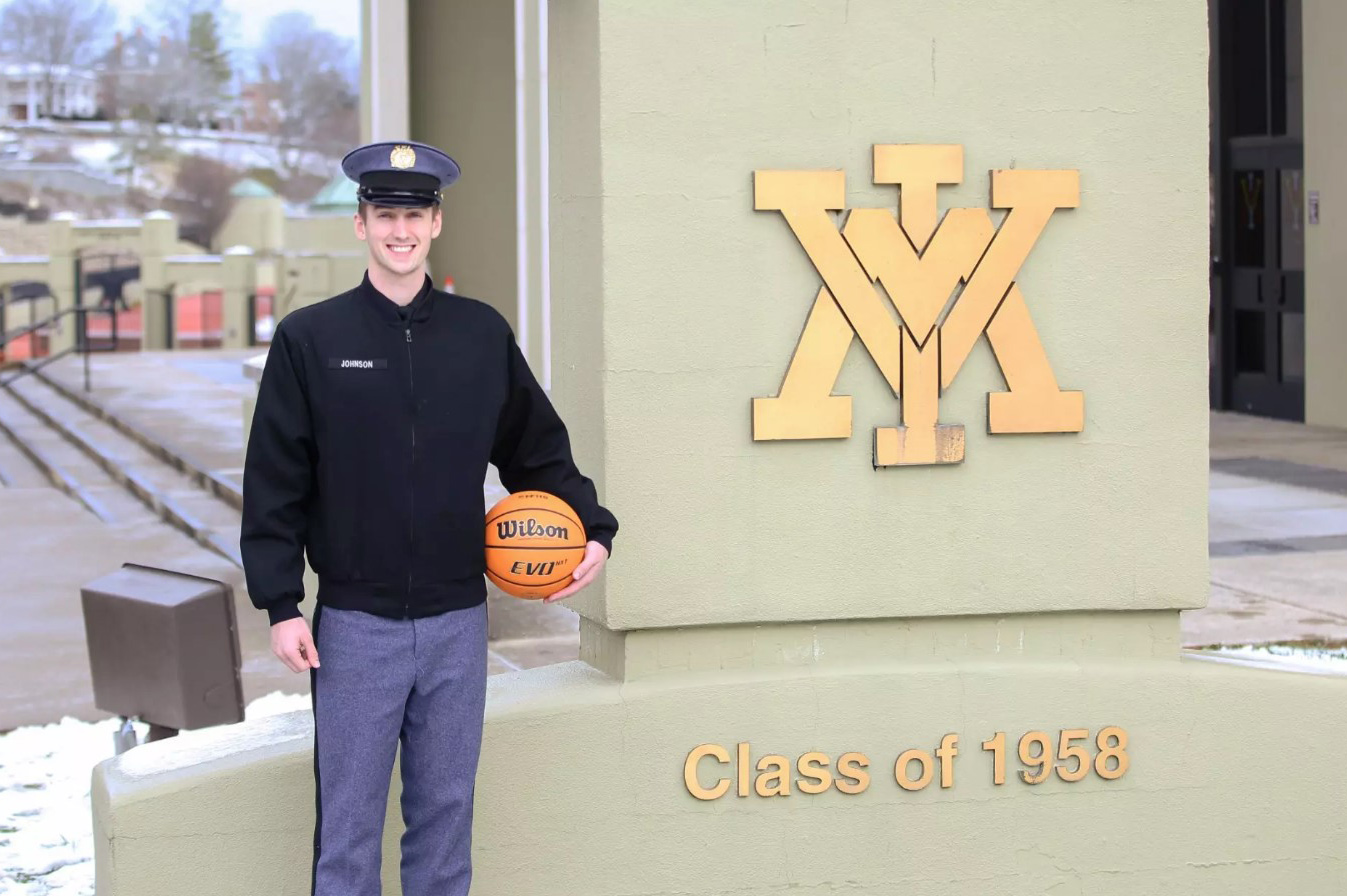 Basketball player TJ Johnson stands outside Cameron Hall.