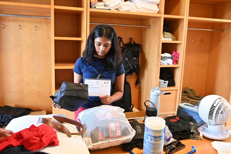 A freshman at VMI - known as a rat - unpacks in her new barracks room, what VMI uses for a dorm.