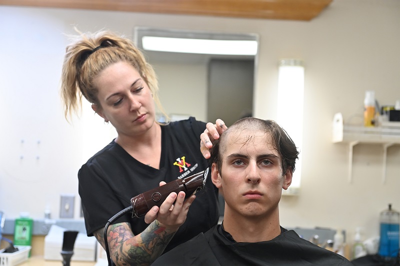 A new rat - freshman at VMI - receives his official regulation haircut at VMI's barbershop.