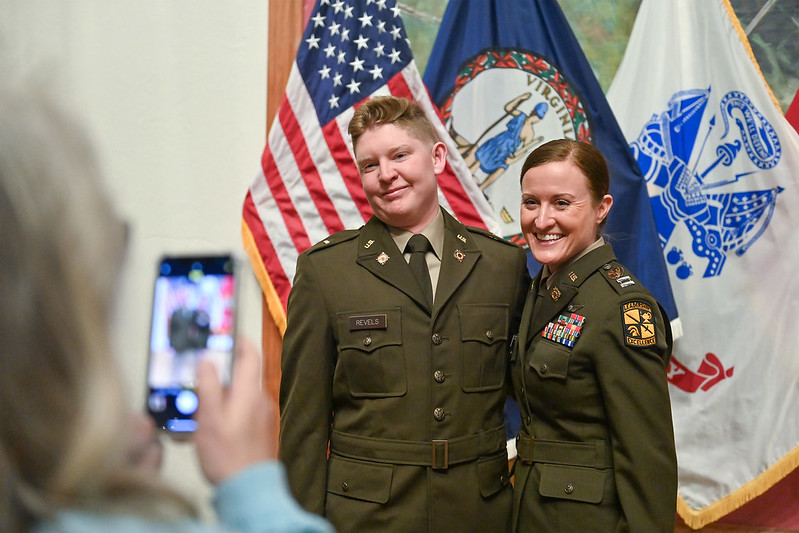 Cadet Revels poses for a photo with CPT Pauliine Johnson as he commissions into the United States Army.