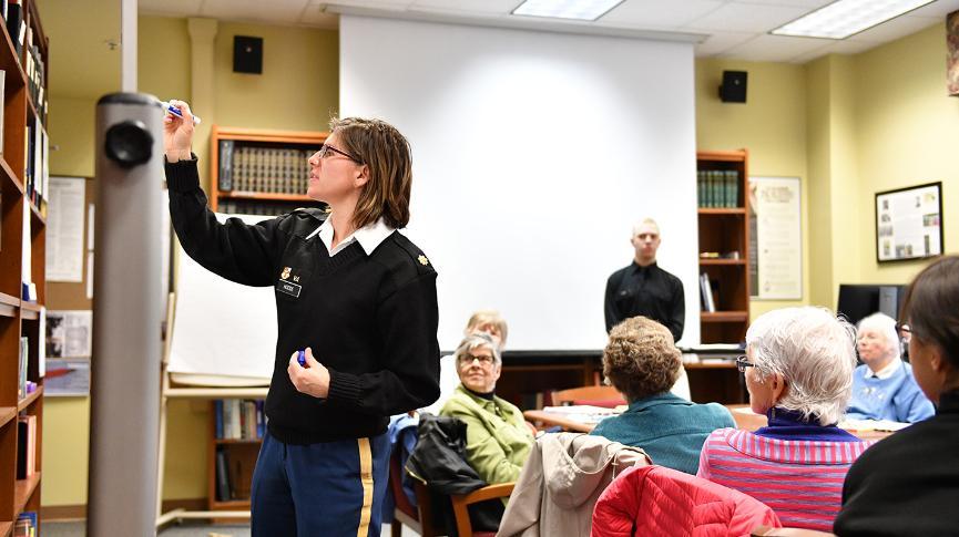 Stephanie Hodde writes on the white board.