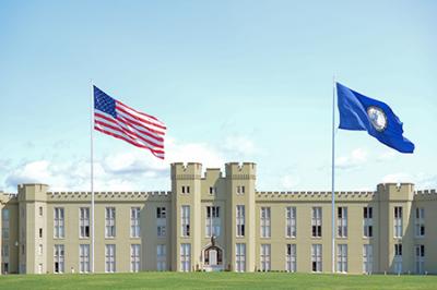 US and Virginia flags fly over barracks.