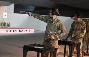 A cadet holding a pistol in the shooting range.