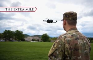 A cadet flies a drone on parade ground.