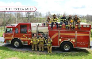 Cadets stand around a fire truck as part of the Lexington Fire Department crew.