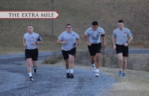 Cadets running along a gravel road.