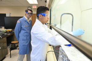 Xavier Zarza ’28 demonstrates the electroplating process while Maj. Christopher Shingledecker observes.