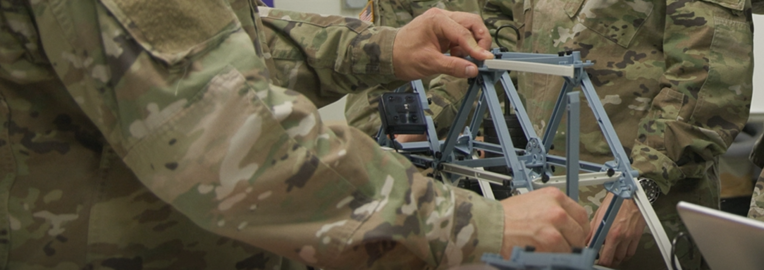 Cadets work on a bridge design.