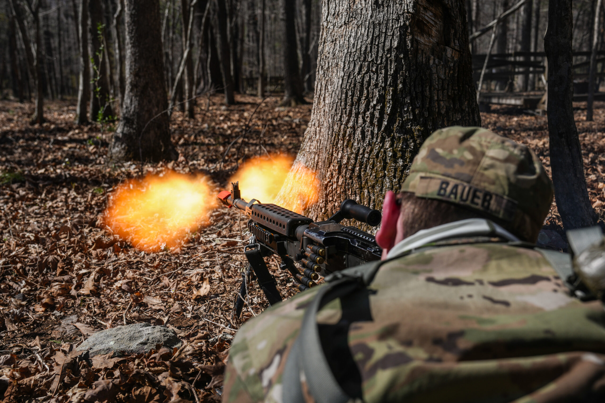 An Army ROTC cadet participates in training in the woods.