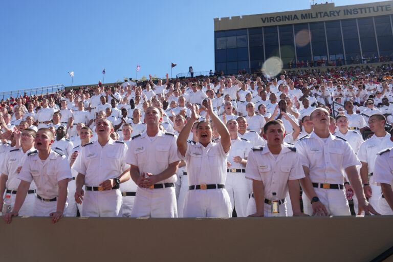 Cadets cheer in the stands of Foster Stadium.
