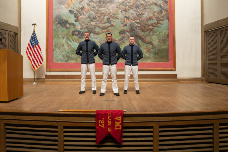 Three leaders crom the Class of 2027 pose at rank announcements.