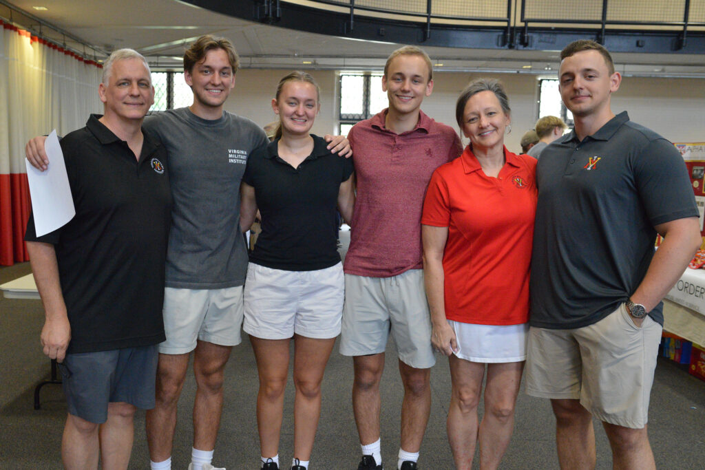 Fraternal triplets Matthew, Olivia, and Daniel Rozsa begin Matriculation Day at the fair surrounded by their parents and older brother, Nicholas Rozsa ’24.