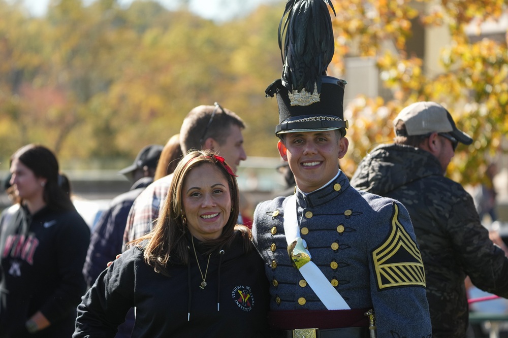 A VMI cadet poses with family members during pre-game tailgating.