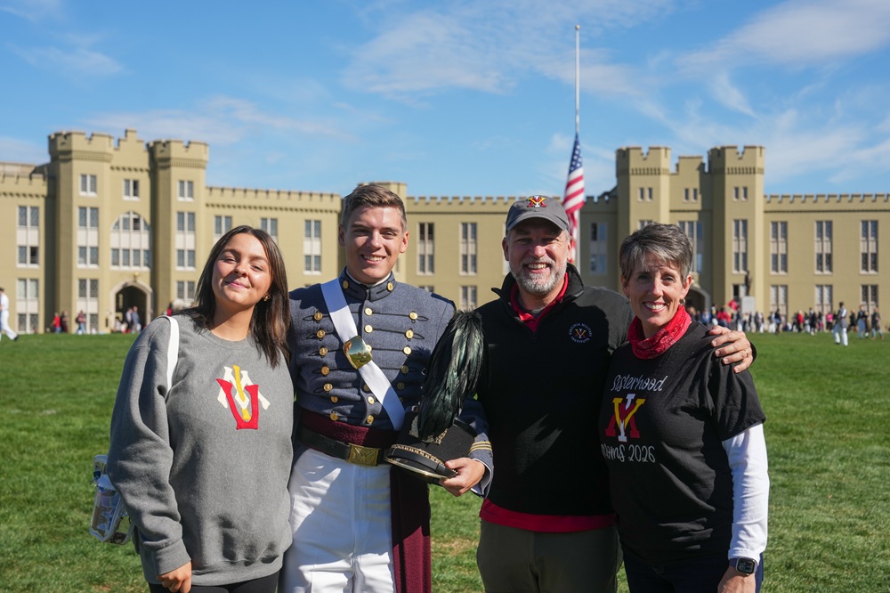 A VMI cadet poses with family members during pre-game tailgating.