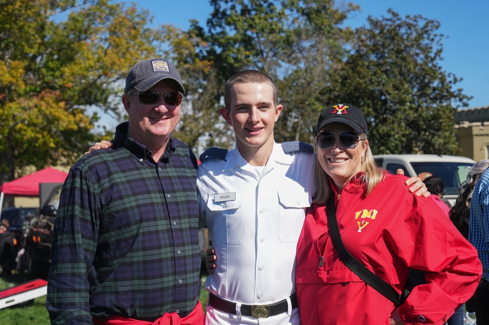 A VMI cadet poses with family members during pre-game tailgating.