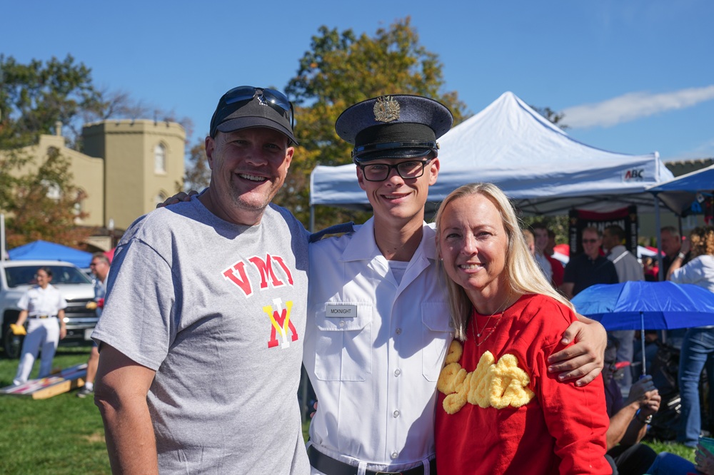 A VMI Cadet poses with his parents.