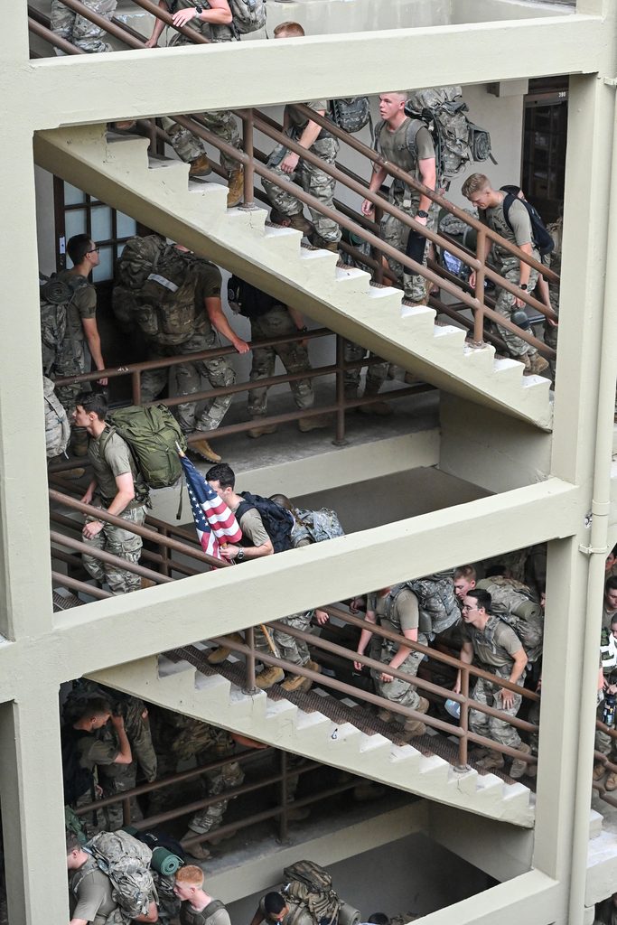 VMI cadets climb stairs in barracks.