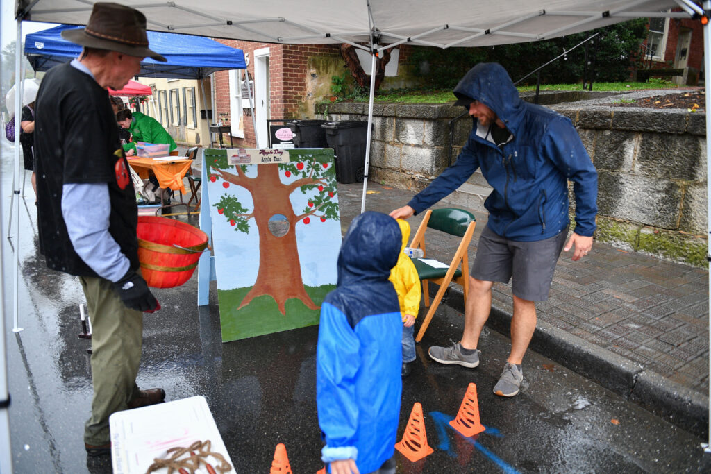 Young history enthusiasts enjoy a game of Apple Toss during last year’s Apple Day at the Jackson House Museum.
