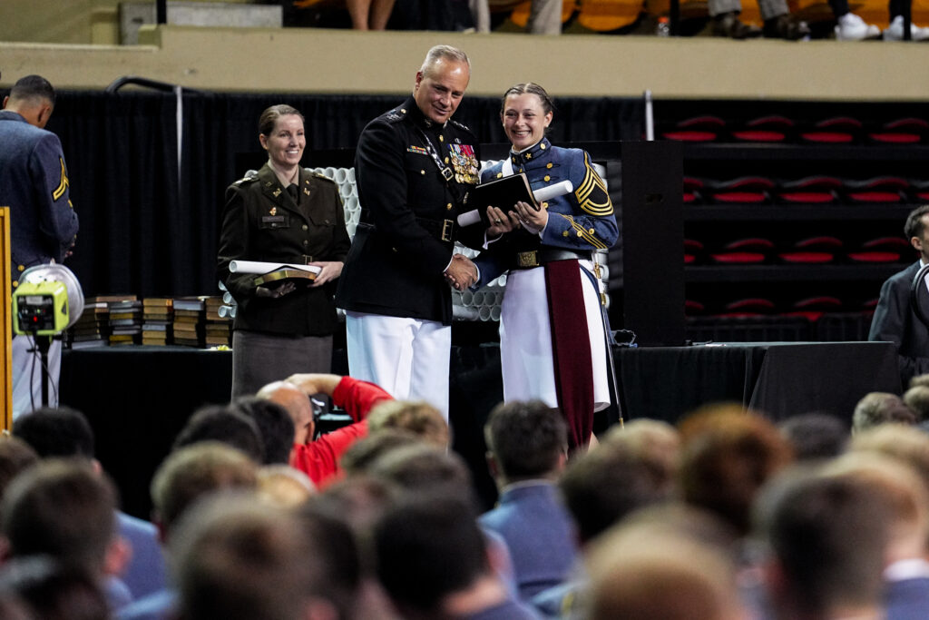 Lt. Gen. David Furness '87 hands out dipolmas during the May graduation ceremony.