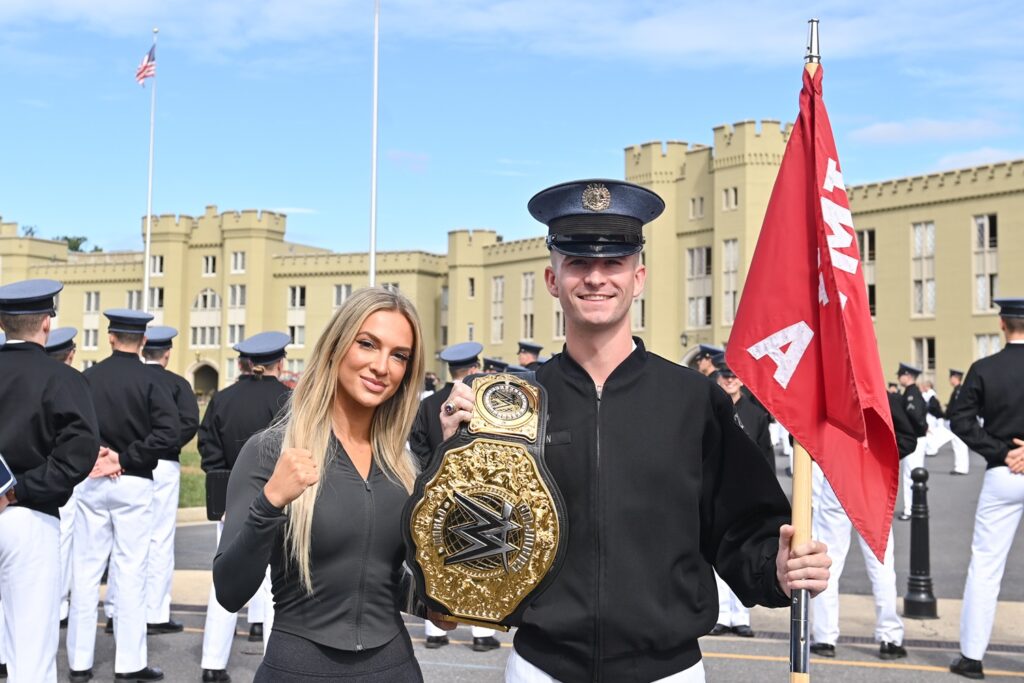 Tyler Hagan ’27 pauses during formation and joins Karmen Petrovic in holding her championship belt. –VMI Photo by H. Lockwood McLaughlin.
