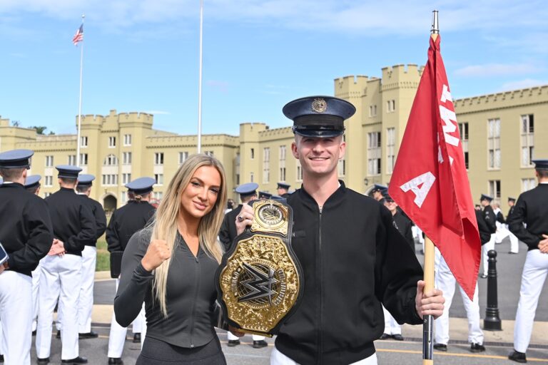 Tyler Hagan ’27 pauses during formation and joins Karmen Petrovic in holding her championship belt. –VMI Photo by H. Lockwood McLaughlin.